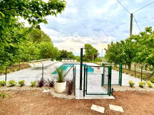 a fence with a swimming pool in a yard at Tenuta EnGi in Verona