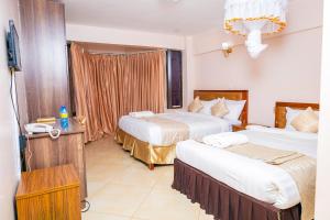 Postel nebo postele na pokoji v ubytování Paleo Hotel and Spa, Thika