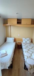 two twin beds in a room with at Quinta das pedras 53 C marconi in Vendas Novas