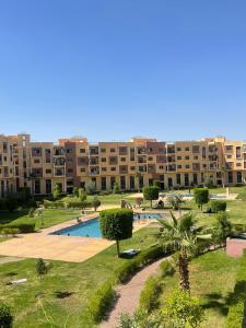 an apartment complex with a swimming pool and a building at Appartement en résidence privée in Marrakesh