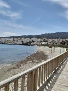 a boardwalk leading to a beach next to the water at Andros Escape Chora in Andros