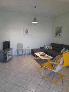 a living room with a couch and a table at Andros Escape Chora in Andros