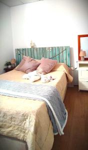 a bedroom with a large bed with a blue headboard at La Mata primera línea de playa in Torrevieja