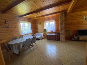 a dining room with tables and chairs in a cabin at Ostoja nad Bugiem in Janów Podlaski