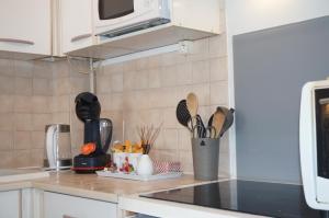 a kitchen counter with utensils on a counter top at Le 33 Cour Normande - Appartement 2 chambres - 2 à 4 personnes - coeur Cabourg in Cabourg +21 photos