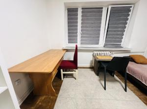 a room with a desk and a bed and a window at Warsaw Lux Rooms in Warsaw