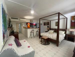 a living room with two beds and a kitchen at Kazalou in Saint-François