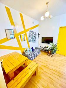 a living room with a wooden table and a couch at SEAWIND CONDOMINIUM RENTALS by AGL in Davao City