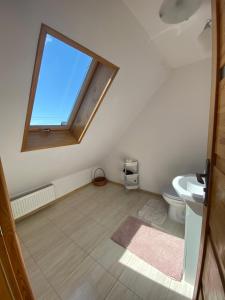an attic bathroom with a window and a toilet at Ostoja nad Bugiem in Janów Podlaski +42 photos