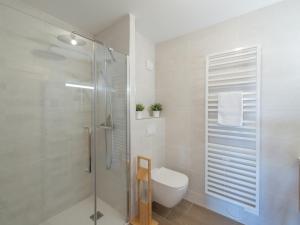 a bathroom with a toilet and a glass shower at Appartement 2 pièces dans une nouvelle résidence de standing - FR-1-645-56 in LʼHuez +9 photos