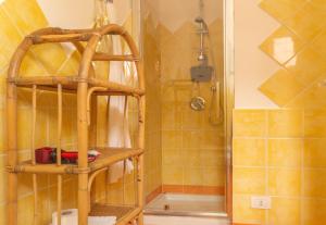 a bathroom with a shower and a wooden shelf at Casa Michela in Palau +12 photos