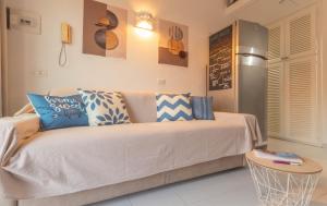 a living room with a couch with pillows on it at Casa Michela in Palau