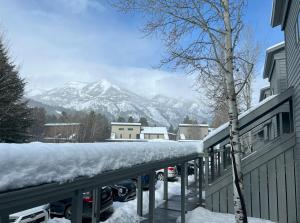 a snow covered parking lot with a view of a mountain at Jackson Hole Vacation Condominiums in Wilson