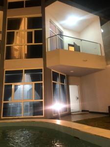 a house with a swimming pool and a balcony at Moonlight in Taif