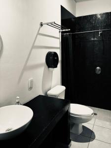 a bathroom with a sink and a toilet and a shower at Hostal Regina Down Town Mexico City in Mexico City