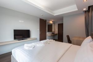 Postel nebo postele na pokoji v ubytování Tisha Hotel
