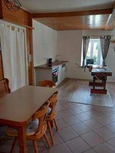a kitchen with a table and chairs in a room at Apartment Antonias Kaffeehäferl in Eibiswald +9 photos