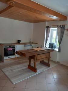 a kitchen with a wooden table in a room at Apartment Antonias Kaffeehäferl in Eibiswald