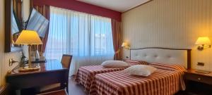 Postel nebo postele na pokoji v ubytování Hotel Benaco Garda ***S