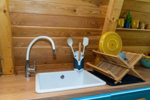 a kitchen counter with a sink and a kitchen utensils at Sunny A Frame in National Park Fruska Gora - Vrdnik in Vrdnik