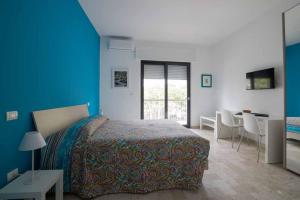 a bedroom with a bed and a table and chairs at B&B Il Sorriso in Bari