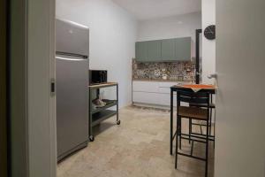 a kitchen with a refrigerator and a table in it at B&B Il Sorriso in Bari