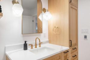 a bathroom with a sink and a mirror at Perch - Emerald Cottage in Seattle +87 photos