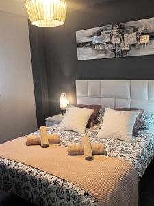 a bedroom with a large bed with two pillows at BEACH&GARDEN in Málaga
