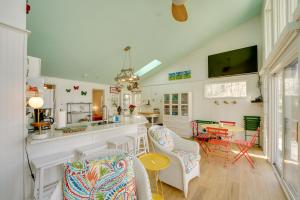 a kitchen and living room with chairs and a table at Beachfront Lake Michigan Cottage with Fire Pit and Deck in Muskegon