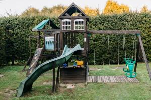 a playground with a slide and a play structure at Ośrodek na zakręcie in Ustrzyki Dolne