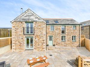 a brick house with a patio in front of it at 3 Bed in Newquay 89943 in Mawgan Porth