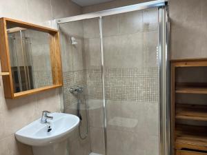 a bathroom with a shower with a sink and a toilet at Habitaciones La MAR in Altea