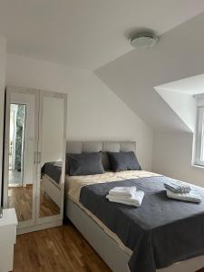 a bedroom with a bed with two towels on it at Apartment Holiday in Vrnjačka Banja