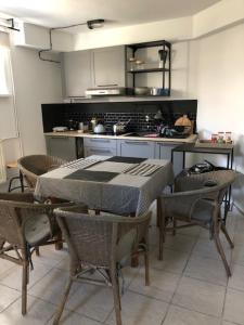 a kitchen with a table and chairs in a room at Ostrowianka in Ostrowo