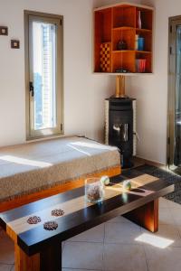 a room with a bed and a table and a fireplace at Villa Dioni in Agios Nikitas