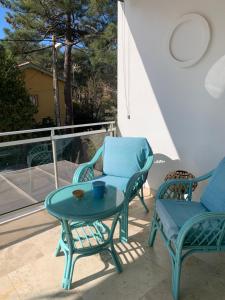 two chairs and a table on a patio at Villa L'Amiraute in Agde