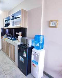 a kitchen with a microwave on top of a refrigerator at Crystal Spheres in Nairobi +3 photos