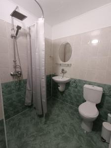 a bathroom with a toilet and a sink at Guest house Marina in Obzor