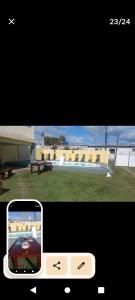 a cell phone taking a picture of a house at Casa praia em Guarajuba-Ba in Camacari