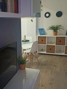 a living room with a table and a chair at BEACH&GARDEN in Málaga