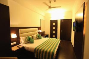 a hotel room with a bed and a television at Hotel Chanchal Continental in New Delhi