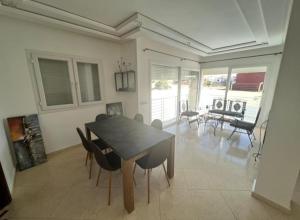 - une salle à manger avec une table et des chaises dans l'établissement Villa avec piscine privée, à El Jadida