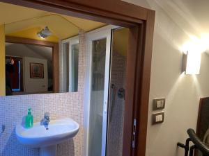 a bathroom with a sink and a mirror at Rosemary 2 in Fano