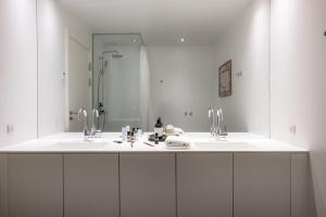 a bathroom with two sinks and a large mirror at The Pier apartments by Daniel&Jacob's in Copenhagen