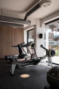 a gym with several tread machines in a room at The Pier apartments by Daniel&Jacob's in Copenhagen