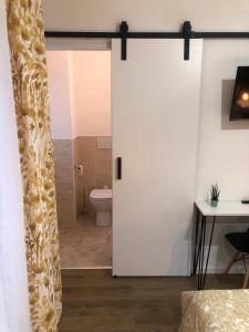 a bathroom with a toilet and a sliding door at A casa di Serena in Ancona