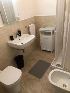 a bathroom with a white toilet and a sink at A casa di Serena in Ancona