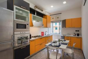 a kitchen with orange and white cabinets and a table at Camogli - "To Palmira" - Liguria Holidays in Camogli
