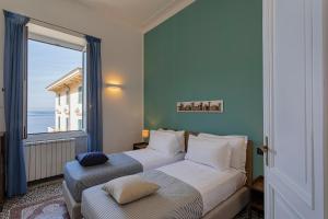 a bedroom with two beds and a large window at Camogli - "To Palmira" - Liguria Holidays in Camogli