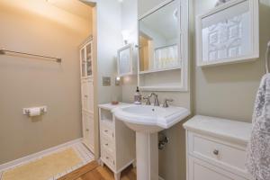a white bathroom with a sink and a mirror at Ancient Oak Sanctuary Rural getaway, walking paths in Grand Junction +32 photos